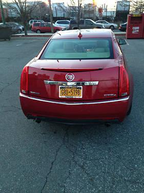 2009 CADILLAC CTS awd, red,automatic 28,600 miles one owner