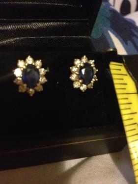A ladies earrings: gold studs with diamonds and sapphire