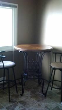 Beautiful wine table with solid wood top wrought iron legs and two nat