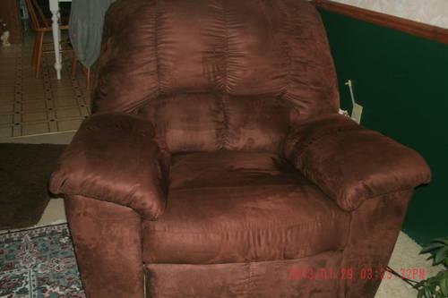 Chocolate brown rocker recliner chair made by Ashley.
