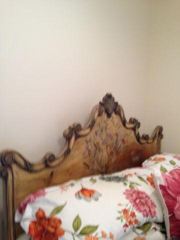 used queen bed with hand-painted headboard