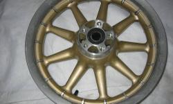 100th Anniversary 9 spoke wheels. Special 100th Anniversary color, Gold & Silver 16" . Front wheel comes with both stock brake rotors. There is no damage to either wheel. Bearings are good and were left in the wheels after they were taken off. Put on