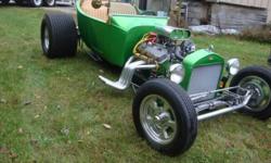 1923 T (registered as 23? Ford Roadster).
Well known Adirondack Nationals Cruiser. Synergy Green with custom accents. 377 SBC (400 destroked) 1400 miles on engine. Trans.- Fresh Turbo 350 and convertor. Ford 9? rear with high way gears. Zoomie Headers.