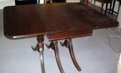 This is a 1940s Mahogany Folding Side Table with detailed trio legs with brass end caps. The table is in very good condition and features two folding extension wings so the table may be also used as a side table.
Table Dimensions: 42"Long x 55" Wide