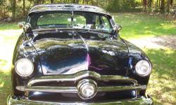 Black Sapphire firemist with light blue interior
1950 Merc block .30 over Jahns pistons Isky cam
Offy heads and manifold 2 Holley 94 carbs
Aluminum radiator 3 speed on column with overdrive
Fenton Headers 2" drop spindles 3" blocks in rear
Headlights and