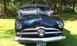 Black sapphire firemist with light blue interior
1950 Mercury block .30 over
Jahns pistons
Isky cam
Offy heads and manifold
2 Holley 94 carbs
Custom aluminum radiator
3 speed on column with overdrive
Fenton headers with glass packs
2 inch drop spindles in