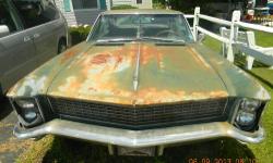 For Sale a 1965 Buick Riveria with the 401 Nailhead cubic inch engine .This Riveria has the Hide-Away Headlights. This classic car has been in a garage for 15 years .The carburator was taken off to get a rebuilt,and is not with the car. It has holes in