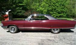 1965 Pontiac Grand Prix Matching Numbers Dark Burgundy Exterior Black Vinyl Top Plum Interior Equipped with a 389 Engine 2 door hardtop Air Conditioning 8 lugs, Dash cluster Garage kept in excellent shape Financing and Nationwide Shipping Available to