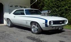 1969 Camaro with a 671 Weiand Supercharged 383 Motor and Turbo 400 Trans and 12 bolt rear.
The car is Dover White with painted Blue SS Stripes. The car was painted in 2006 and shines up really nice. The paint is way better than driver quality and cost