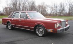 Theres no other way to say it, this Lincoln looks new new new in every way! Twenty six years with the same owner was obviously a good thing. The Maroon colored finish is nearly without fault, as is the dark colored burgundy velour interior. This Town Car