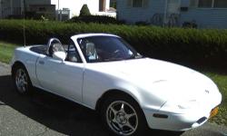 1990 White 5 speed.Mazda Miata, New paint, Stereo, brakes, water pump, timing belt, radiator, roll bars. In EXCELLENT Condition. Very Clean, Well maintained . Was just tuned up and inspected. Top does not leak. This Car needs Nothing. Looks and Runs