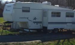 98 Starcraft 5th wheel camper with slide. Excellent condition with NO leaks. Stove, gas/electric refrigerator and hotwater heater, furnace, central air conditioner. am/fm w/ cd player, Awning, Fiberglass siding, Queen size walk around bed. Easy to pull!!