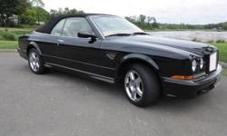 Very rare and highly collectible 2002 Bentley Azure, Wide Body Mulliner. Finished in Black with Tan Hides and Black Piping this is one of about five total Azure Wide Bodies produced in 2002, this stunning motorcar something you might never see again and