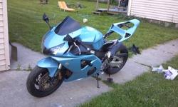 2002 honda cbr 954rr custom. Has new paint with 250.00 in pearl alone. Shins in the sun. Has a 2004 cbr 1000 tail section put on by a local customize shop. Custom upholstered black carbon fiber seats. Aftermarket full exhaust. Smoked led tail light.