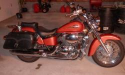 2003 Honda Shadow ACE 750 (American Classic Edition). It only has 12,295 miles on it. It's a beautiful bike and rides very nice. It also has a lot of chrome extras, including the highway bar, front foot pegs, extra large saddle bags, second seat backrest