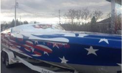 This immaculate boat features a 496 H.O. motor, allowing you to cruise long at about 70 mph in comfort and style. You will not find a more patriotic custom paint job that turns heads wherever you go. This boat has always been stored indoors, and is in