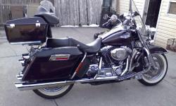 Selling a 2005 Harley Davidson Road King, black cherry paint, fully loaded and dressed with loads of chrome. 64K miles. Has Vance & Hines full exhaust, Screaming Eagle tuner, J & M speaker set, satellite radio, wind screen, removable tour pack with back