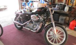 2007 Harley Davidson Sportster 883 Custom. Black. Saddlebags included. Low mileage. Approx. 3500 miles
