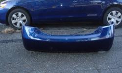 2007 Toyota Camry rear bumper cover in blue for 4 cylinder. Some minor scrapes/scuff marks and 1 missing rubber tab (see photos).