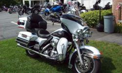 THIS IS A GREAT LOOKING, GREAT RUNNING BIKE. The previous owner added heated grips, chrome instrument trim, front light visors, Screaming Eagle slip on exhaust, highway pegs,
and a Mustang seat with the rider backrest. The art work on the fairing and the