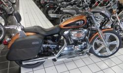 This is a really nice Anniversary 1200 Custom. CHECK IT OUT !!!
Looks good, runs great, and it has a few add ons. Custom wheels, and chrome front lower legs to start with. Then you have a pair of custom grips, a set of slip on exhaust for sound, a pair of