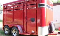 Special order 12' stock/horse trailer in as new condition. This trailer was ordered with the extra height and width options making the inside measurements 12' long, 6 1/2' wide, and 7' high along with extra high side panels. The rear swing gate has a