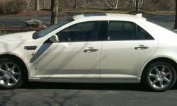 2009 STS Cadillac with AWD, sun roof, heated seats, lumbar hooked up for OnStar, CD changer for 6 cds. GPS and many more features. It is loaded. Beige Interior, leather seats. 4 door sedan. V6. It gets 25 miles a gal. and even better on long trips.