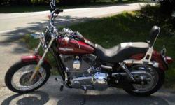 2009 Harley Davidson Super Glide Custom Cruiser 2009 Harley Davidson Dyna Super Glide Custom. Color Sun Glo Red Has less than 2,100 miles. Added forward controls, reach seat, rush pipes, and back rest. Also has stock seat and pipes. 3 helmets and leather
