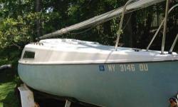 20' 1973 Ensenada Sailboat on a sturdy trailer for sale with many, many extras! This is a 20' fiberglass boat with a swing keel and rudder. The cabin sleeps 4 and also has a swing up table, counter top and pump sink. Included is also a Merc 4.5 HP in mint