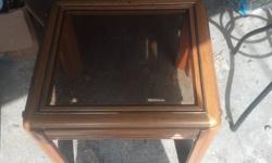 This end table is in good shape. Glass has no chips in it. One of the legs is a little loss but the table stands fine and can barely notice it. Im sure it can easily be fixed with super glue or wood glue. The table is 22 inches wide, 24 inches long. 15$