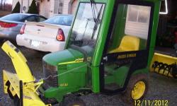This has a 20hp liquid cooled kawasaki motor,power steering,hydrolic lift,42 inch snow thrower,nice inclosed cab,54 inch mower deck,chains and weights. Runs and works perfect!