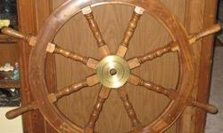 I have an old ships wheel, heavy and must be picked up, I think it is teak, hub is solid brass, great wear on the wood from use, has been hanging in my bar for years, solid construction, 42" diameter x 2" deep. For decoration or USE.
