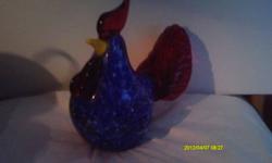 His lush plumage gleams a deep, sapphire blue, shot through with copper lights
A flourish of ruby-red glass forms the cock's comb, wattles, and tail
His beak is a crescent of sunshine yellow
Handcrafted of fine art glass
Bears the Lenox hallmark