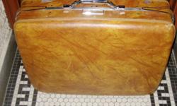 This American Tourister suitcase is 24 inches wide, by 18.5 inches high, and 8 inches deep. It comes with a hanging frame for suits as well as three hangers and a lock combination device that is part of the suitcase.
It has been used, has a few nicks and
