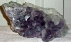 Amethyst Crystal Cluster with huge Nuggets.They are only found in one area of the world and only in a ten by ten mile location. This geode is a classic example of the gem quality Amethyst that comes from Rio Grande do Sul, Brazil. This amethyst section