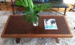 This beautifully hand-crafted, vintage coffee table has a faux-leather inlay and uniquely designed legs. Its Belgian-inspired, mid-century aesthetic will bring charm to any living or working space. Wood is in great condition and has a soft, cherry finish.
