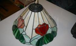Antique Leaded Stained Glass lamp shade from England.
Can be used for lamp or hang from the ceiling.
Wired for European power but can be changed with very little effort or taken out completely to use on a lamp. Two very small cracks that do not affect