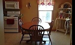 Mission style, solid oak. 48" round table with 4 - 12" leaves. 6 chairs. Good condition.