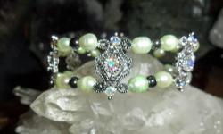 Beautiful handmade Antique Silver Color design Bracelet with White Clear Swarovski Crystal, Light Green Fresh Water Pearls, Black Hematite Beads and Silver loop lock. One of a kind Bracelet and Perfect with Perfection. In real time the Bracelet is just