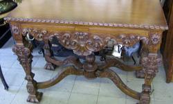 This an undated antique Walnut carved side table. Very beautiful and ornate carvings all around with scalloped edges of the top. This table is in very good to excellent condition with very few marks or scratches. Some shrinkage and a few minor cracks on