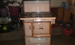 Antique wood stove from early 1900's. Stove works and is in good condition. Take as is. Stove needs to be picked up.