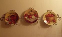 I am selling a set that includes three plates with different designs involving apples on them, two votive candle holders and the wire rack that everything is displayed on. This is a beautiful set without any chips in the plates. Great for a kitchen or