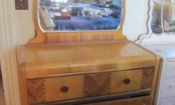 This bureau is in great condition for its age! Beautiful detail as you can see by the photo. It has 3 drawers and a beautiful scalloped mirror. Solid wood. I added two pieces of wood to the back just as extra reinforcement for the mirror. If you have any