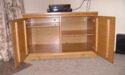 This Ashley Candelight Pine TV Stand has a Length of 46 inches a Width of 24 inches and a Height of 30 inches, with doors on the front and adjustable shelves inside.Excellant Condition.