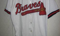 This quality Atlanta Braves extra large jersey by Russell has never been used. It sells for $40. With it at no extra cost is the pictured Atlanta Braves Chop.
This brand new size large short sleeve golf shirt is a hole in one. It is cotton and features