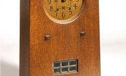 This listing is for an authentic Stickley "Prairie Style Mantle Clock" #89-085. It was purchased from Audi Stickley. The clock is made from oak and it measures 22" H x 16" W x 8" D. It has an art glass panel inset and come with instructions and the wind