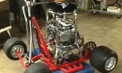 6 1/2 horse electric start bar stool racer. Great for cruising the pits at the race track or putting around the camp grounds. I put a bigger sprocket on the rear axle to slow it down so I wouldn't kill myself. It comes with wheelie bars if you want to