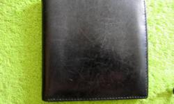 barely-used black leather credit card case with space for bills, has 10 slots for credit cards and side slots for additional cards-has minor scratches and one very small tear