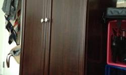 Purchased only a few months ago, this Armoire is a cherry wood finish.
Need to buy a new and larger unit for all my clothes, so I'm letting this go. I purchased for $350.00 on line, and since I assembled I am not negotiable on the price.
Wooden bar for