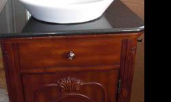 antique look vanity with white bowl sink.. Standard size. Nice faucet set included.. Black granite top.. New condition barely used before taken out.